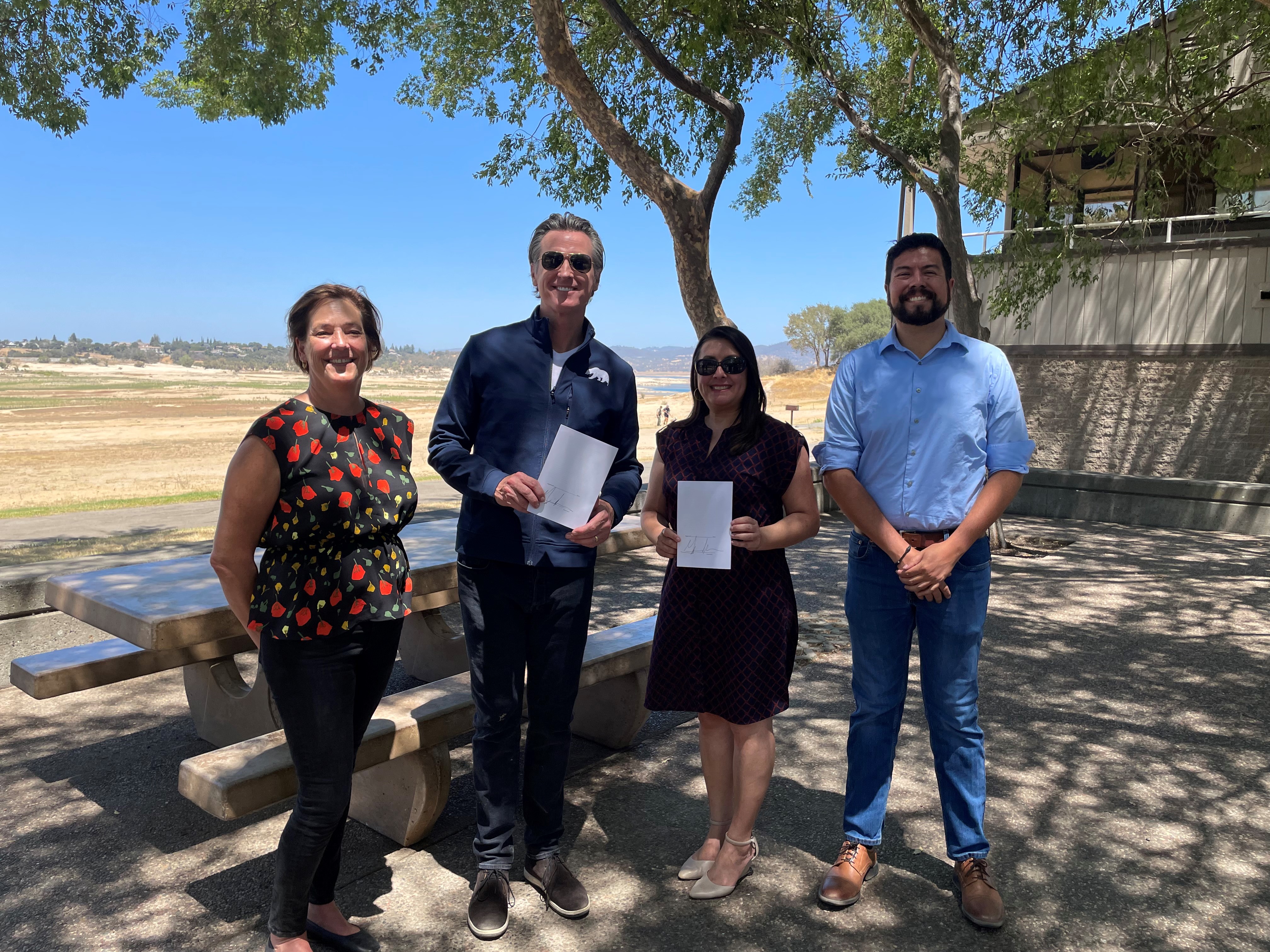 Pictured: Department of Water Resources Director Karla Nemeth, Governor Gavin Newsom, Assemblywoman Luz Rivas, and State Water Resources Control Board Chair Joaquin Esquivel following the AB 148 bill signing at the Folsom Lake reservoir.